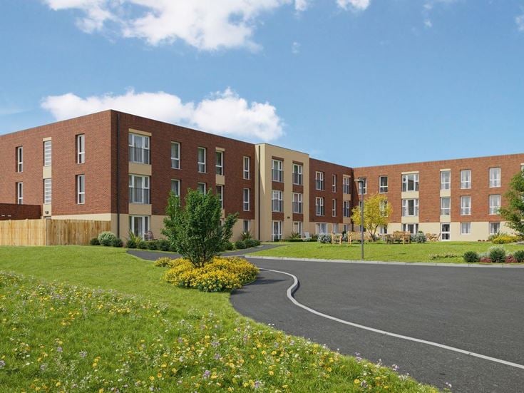 a large brick building with a parking lot in front of it