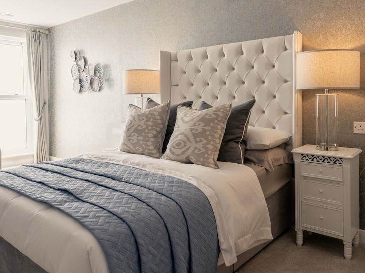 a bed with a white bed spread