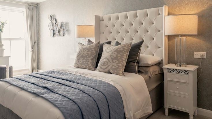 a bed with a white bed spread