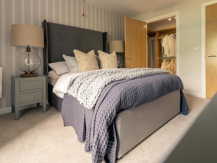 a bed with a blue and white comforter