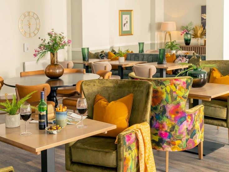 a living room with a table and chairs