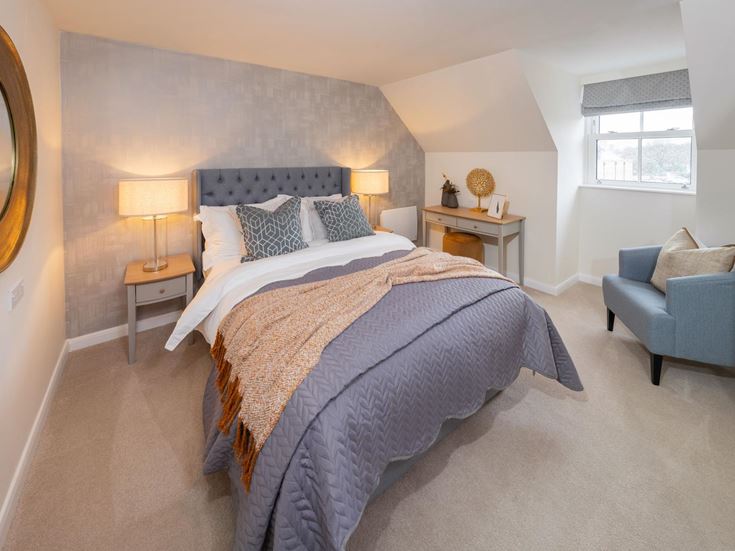 a bedroom with a bed and a chair