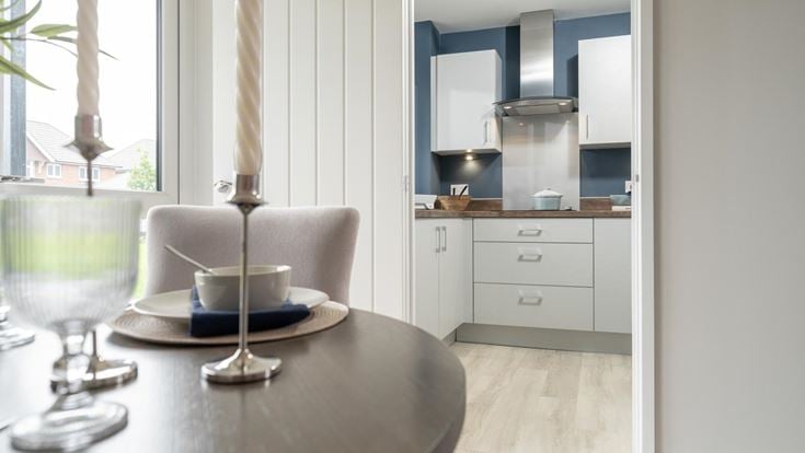 a kitchen with a table and chairs