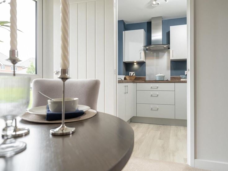 a kitchen with a table and chairs