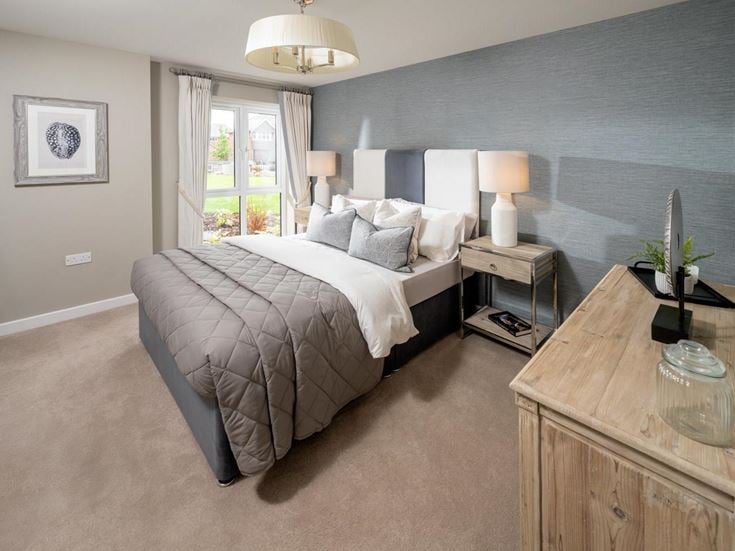 a bedroom with a bed and a table