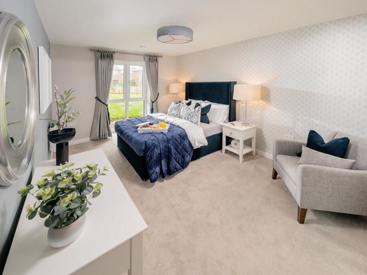 a bedroom with a bed and couches
