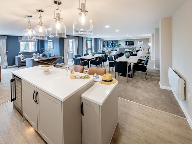 a kitchen with a bar and dining area