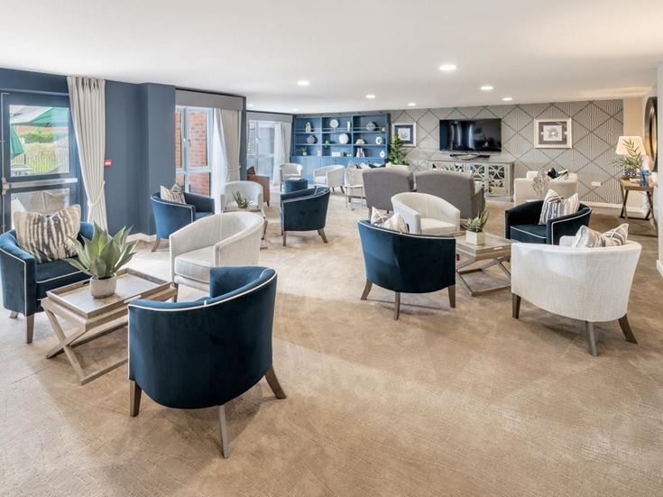a room with a couch and chairs