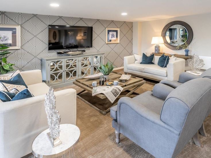 a living room with a large tv and couches