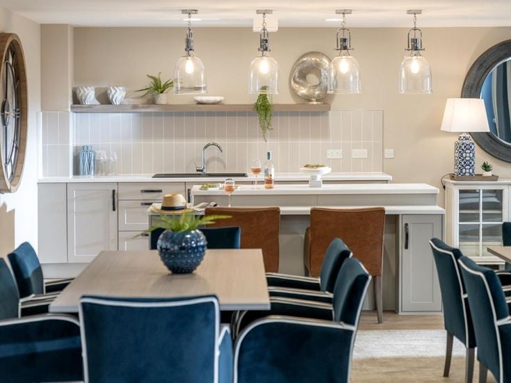 a kitchen with a dining table and chairs