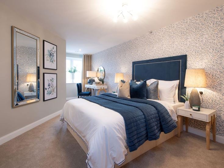 a bedroom with a bed and a mirror