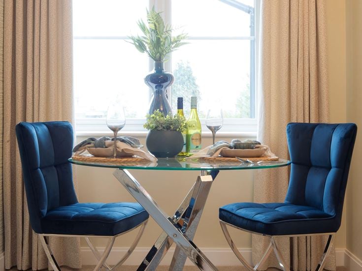 a table with chairs and glasses on it