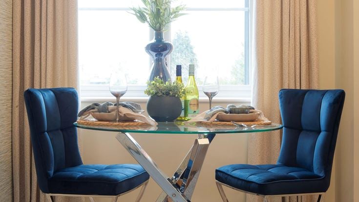 a table with chairs and glasses on it