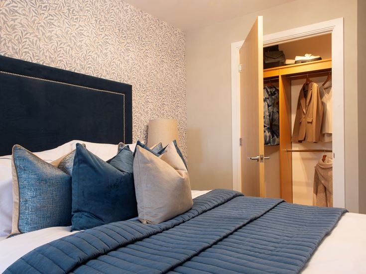 a bed with blue pillows