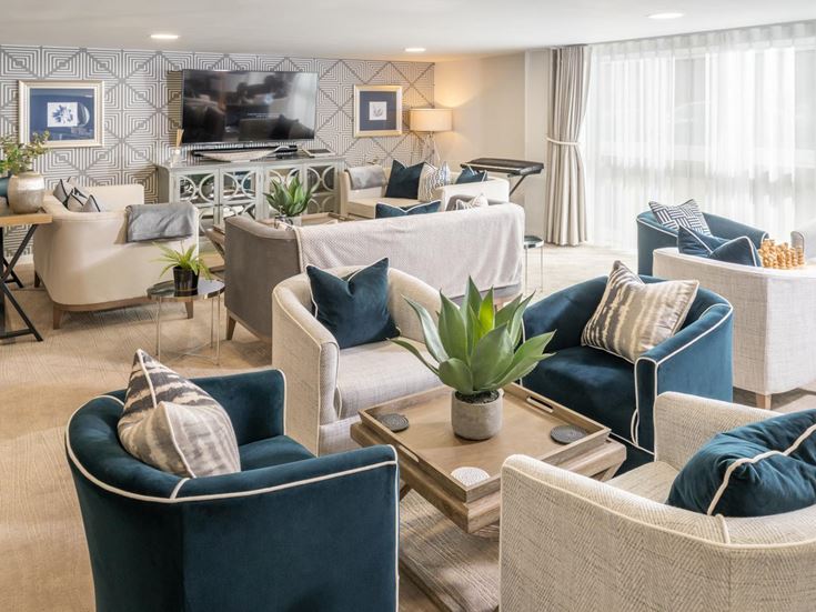 a living room with a tv and chairs