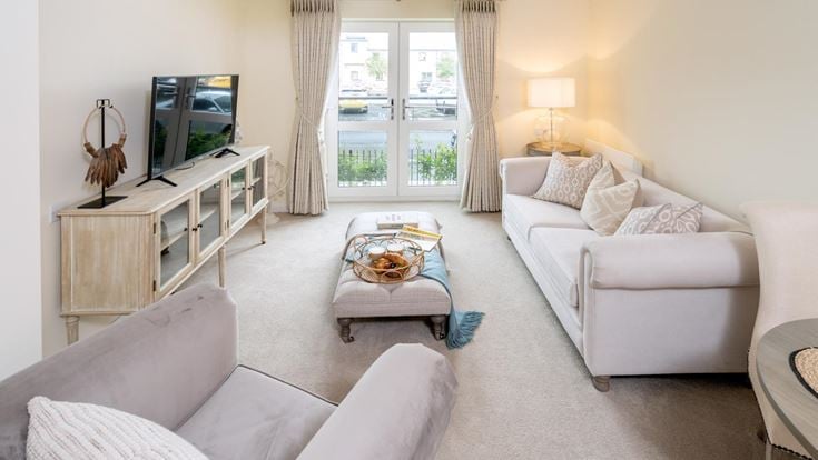 a living room with white furniture