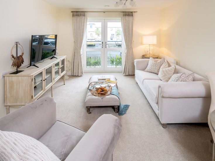 a living room with white furniture