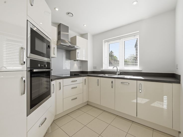a kitchen with white cabinets