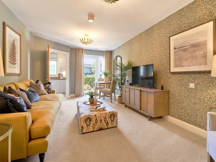 a living room with a large tv and couches