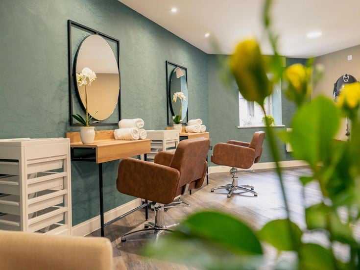 a room with a mirror and chairs