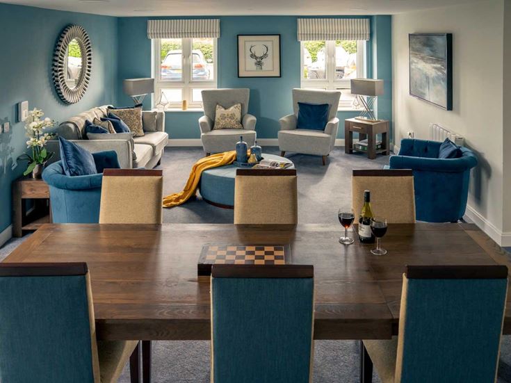 a living room with a table and chairs
