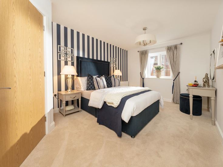 a bedroom with a bed and a desk
