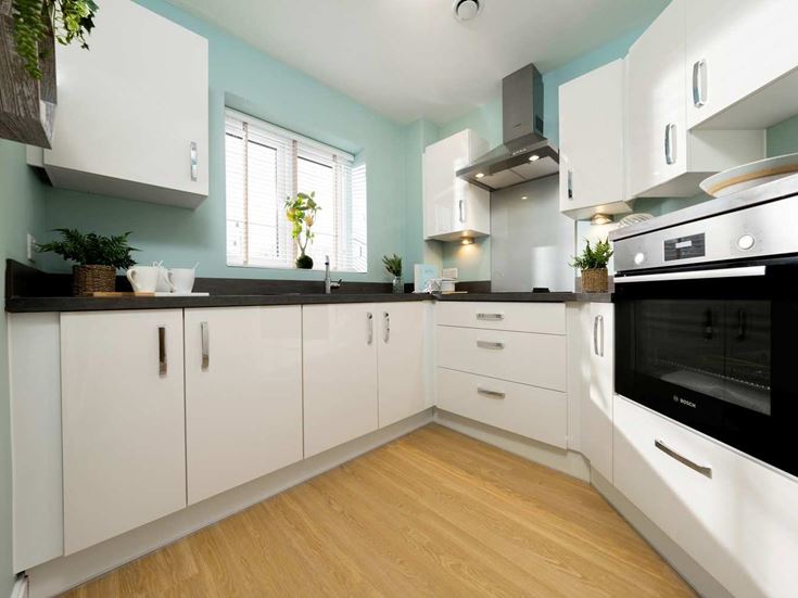 a kitchen with white cabinets