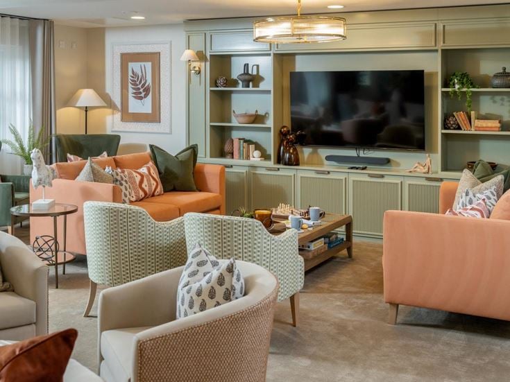 a living room with a tv and couches