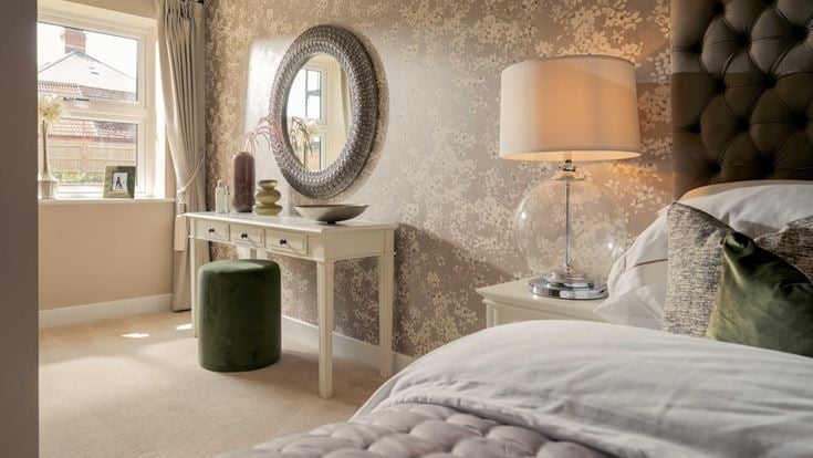 a bedroom with a mirror and a lamp