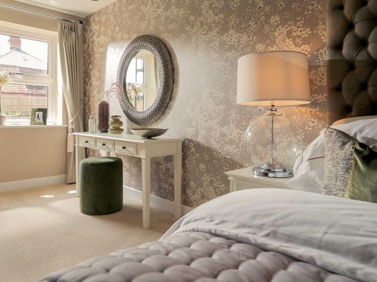 a bedroom with a mirror and a lamp