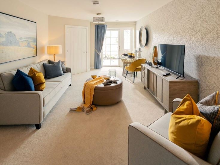 a living room with a tv and couches