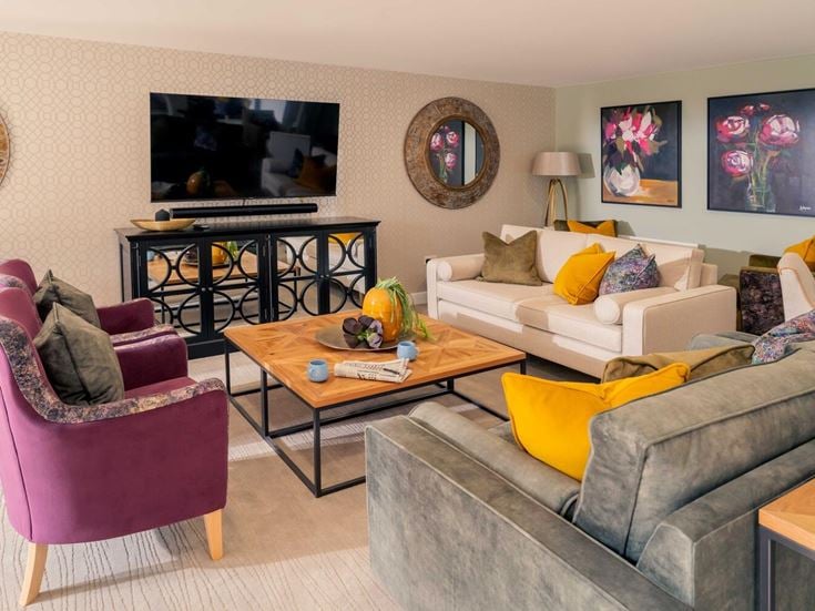 a living room with a tv and couches