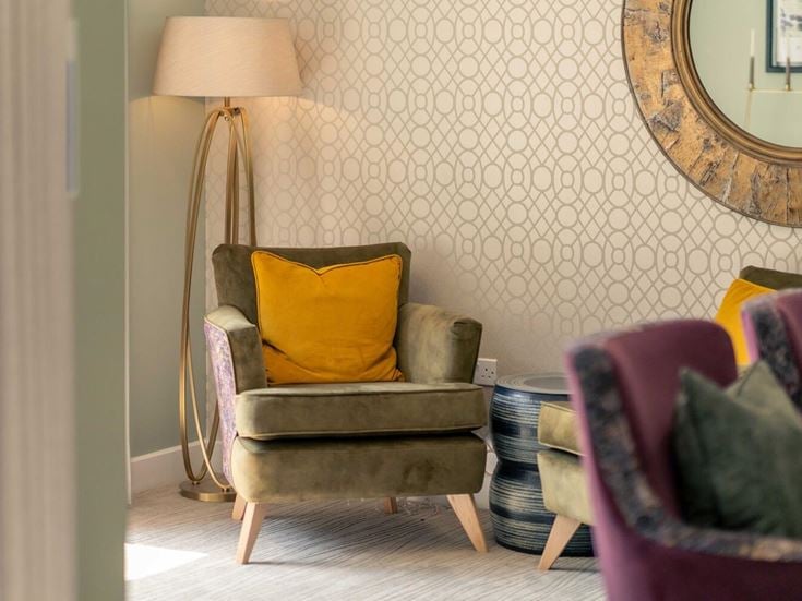 a living room with a lamp and a couch
