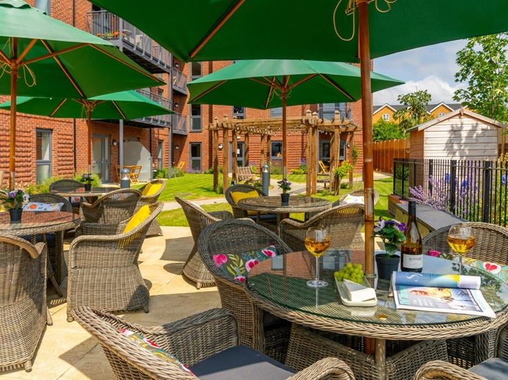 a patio with tables and chairs