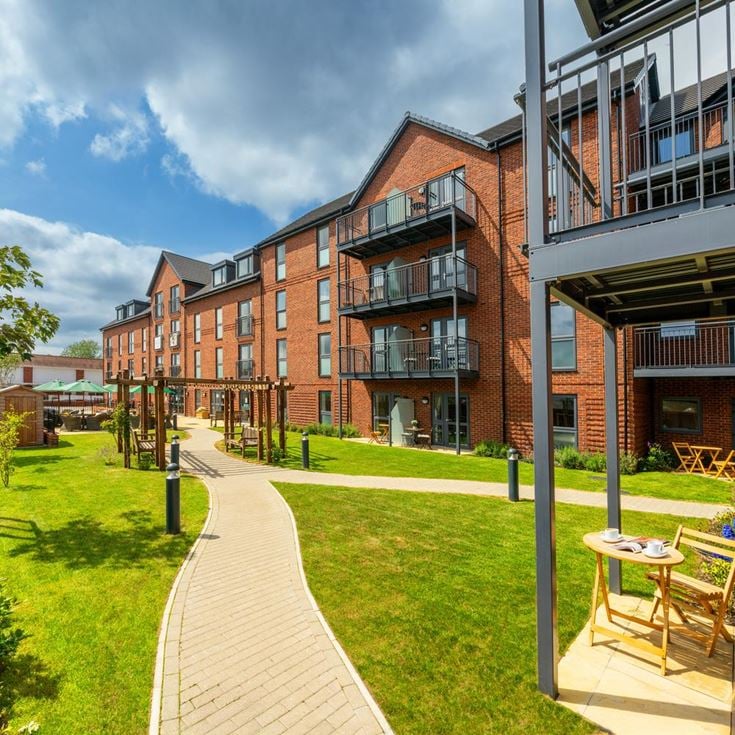 a building with a walkway and grass