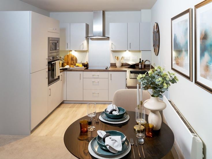 a kitchen with a table and chairs