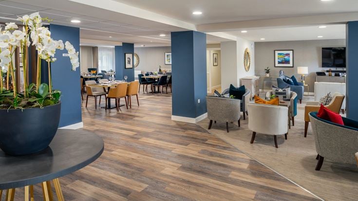 a room with a wood floor and chairs and a wood floor