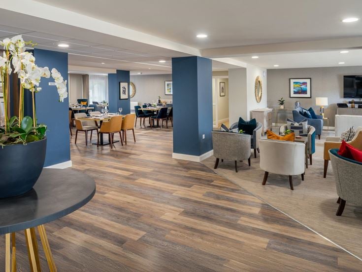 a room with a wood floor and chairs and a wood floor