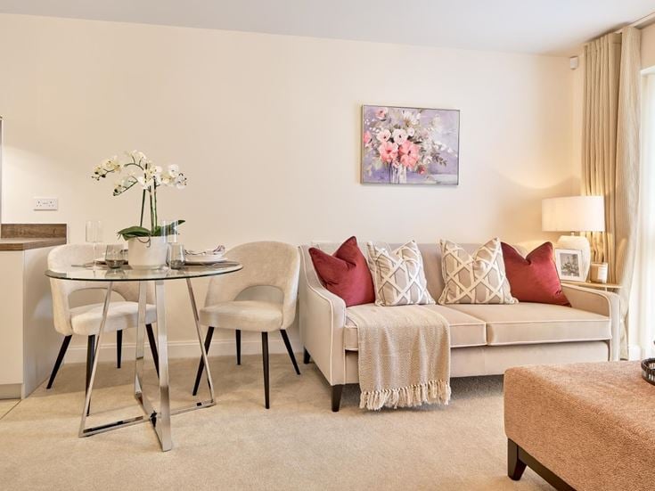 a living room with a white couch and a table