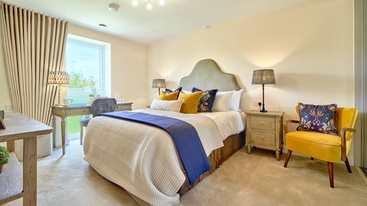 a bedroom with a bed and chairs