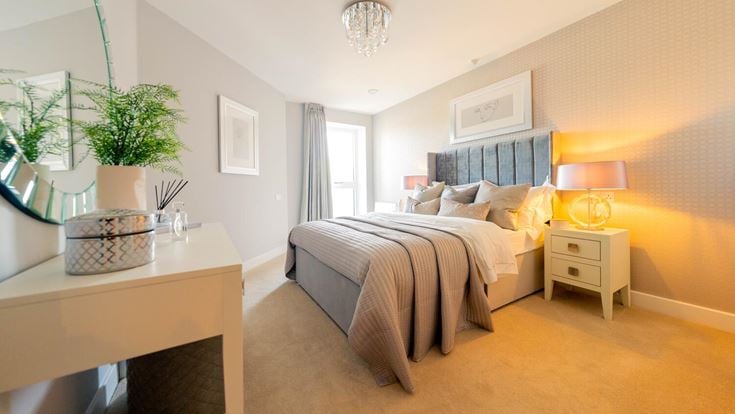 a bedroom with a bed and a table