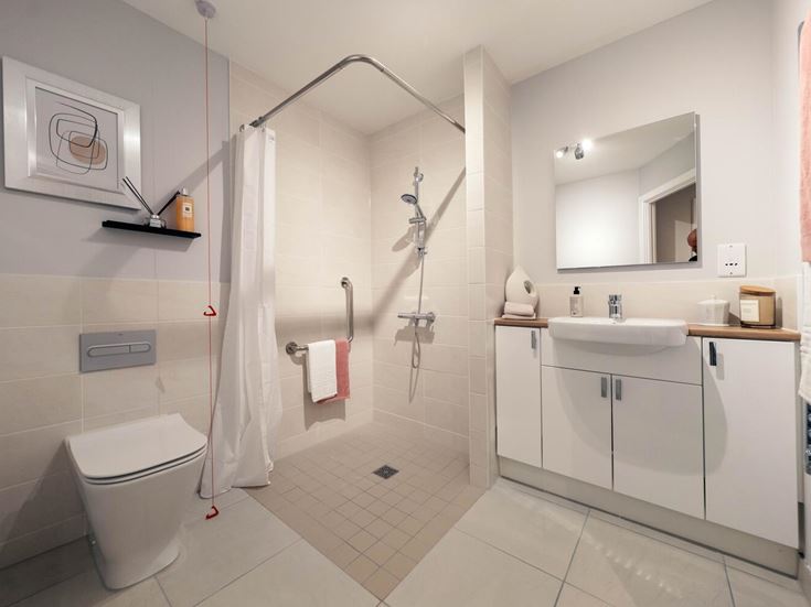 a bathroom with a shower unit and toilet
