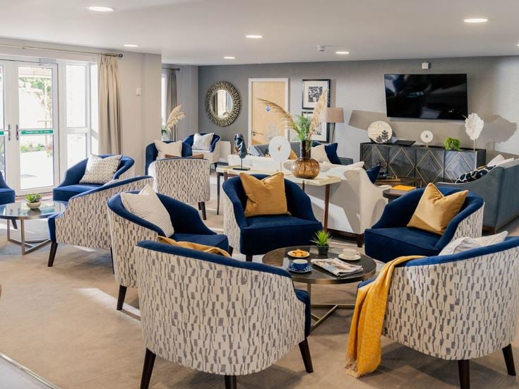a living room with blue chairs