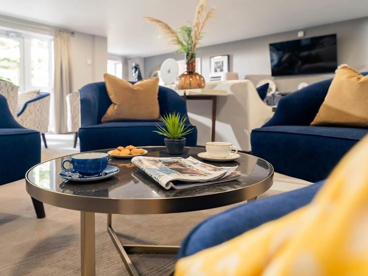 a living room with a coffee table and couches
