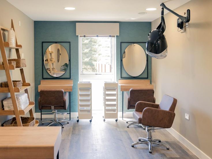 a room with a table chairs and a mirror
