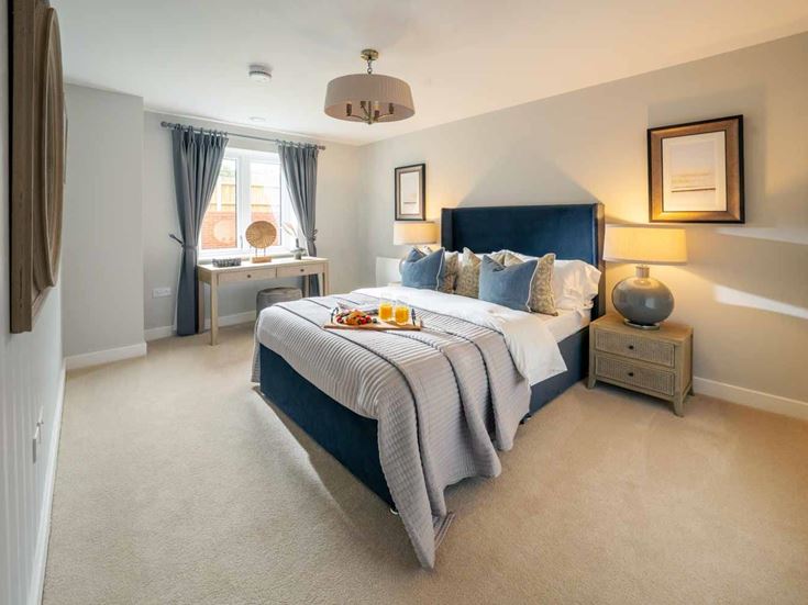 a bedroom with a bed and a table