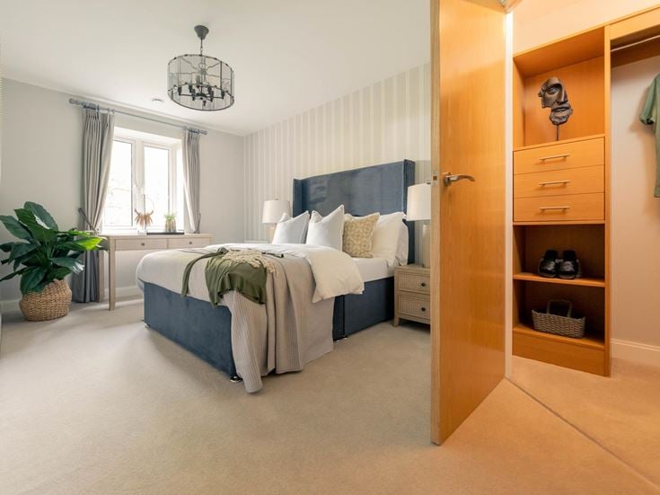 a bedroom with a bed and a shelf