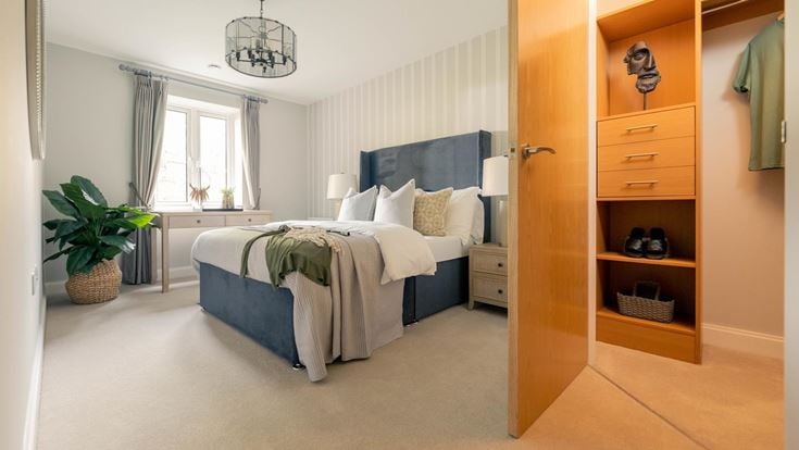 a bedroom with a bed and a shelf