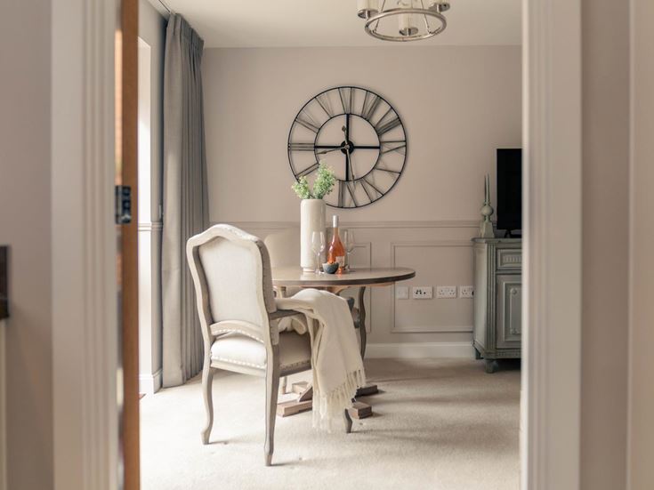 a dining room table with a clock