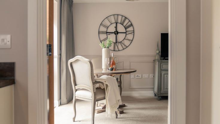 a dining room table with a clock
